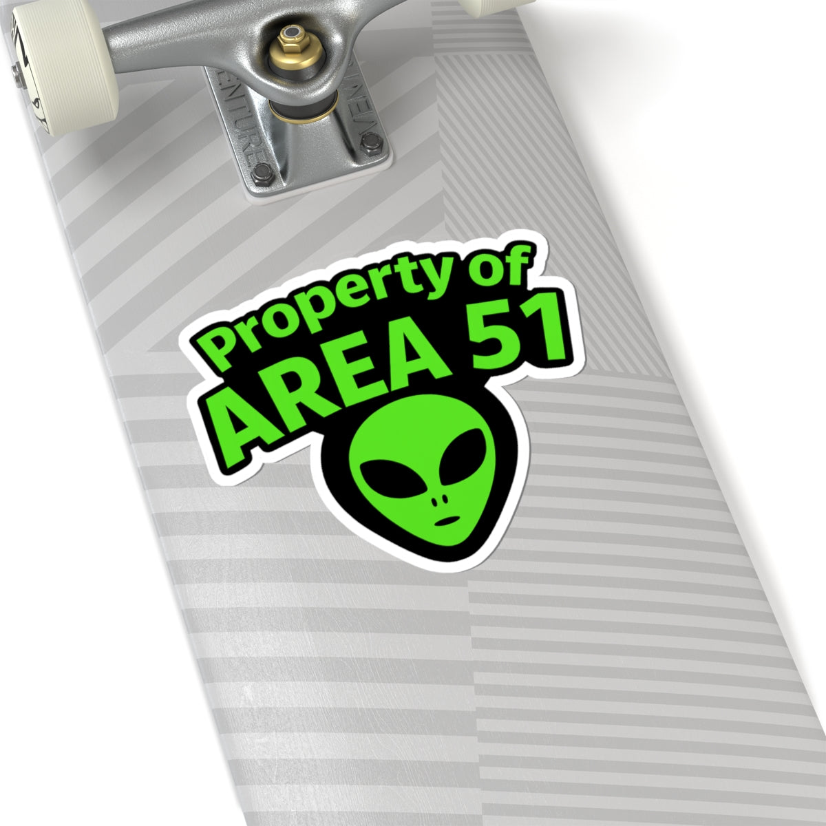 Skateboard with 'Property of Area 51' alien head sticker on a white background